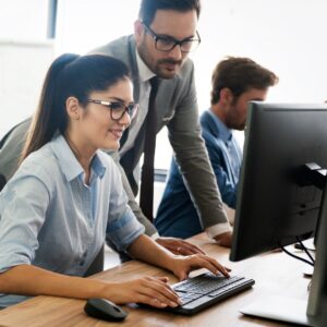 People working at a computer in an office