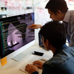 team looking at desktop monitor