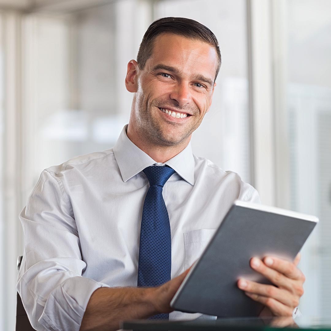 smiling business man using a tablet