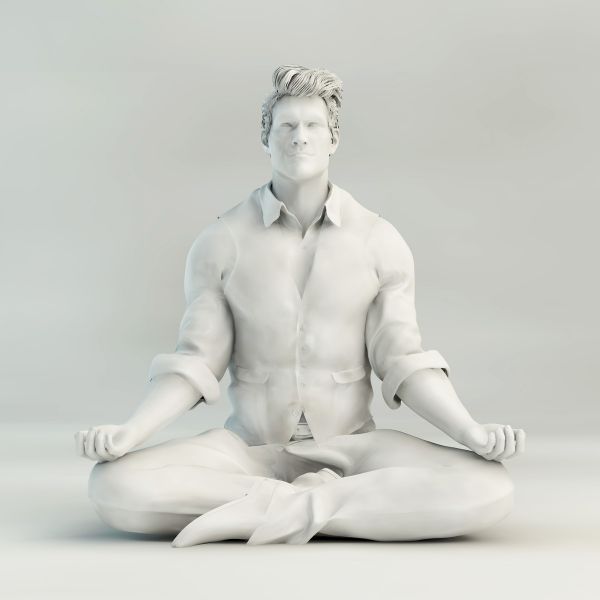White sculpture of a man meditating