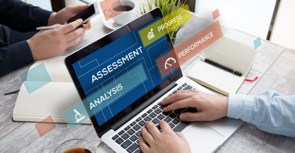 laptop with words overlaid like assessment, analysis, and compliance