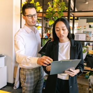 Two workers discussing a file
