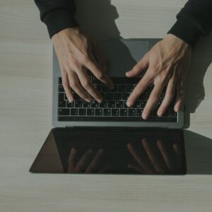 Someone typing on a laptop